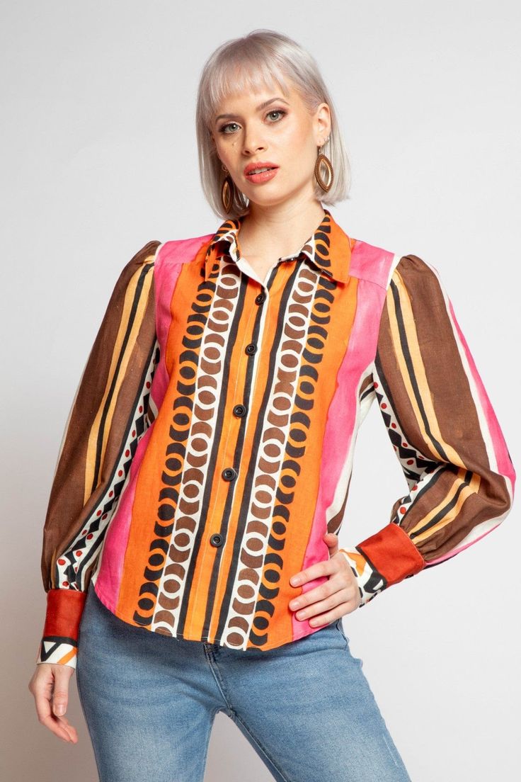 Add some playful style to your wardrobe with the Lorca Blouse in Tulum Stripe. Made from soft geometric linen, this collared shirt features a front button closure and long sleeves. Perfect for a casual day out, pair it with your favorite jeans or white pants for a fun and quirky look. Spring Multicolor Blouse With Collared Neckline, Multicolor Collared Blouse For Work, Multicolor Collared Shirt For Spring, Multicolor Spring Shirt With Collared Neckline, Multicolor Collared Blouse For Workwear, Multicolor Collared Shirt For Work, Multicolor Collar Blouse For Work, Long Sleeve Blouse With Bold Print For Work, Multicolor Spread Collar Blouse For Spring