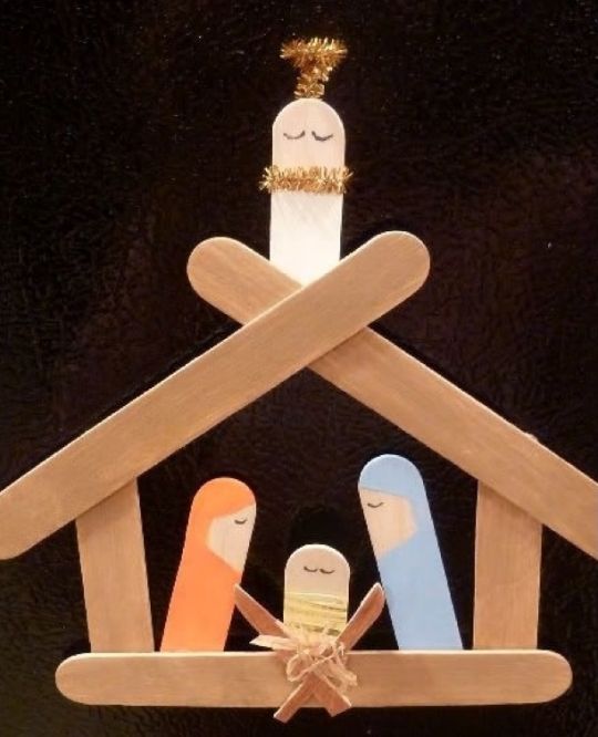 an ornament made to look like a house with three people in the roof