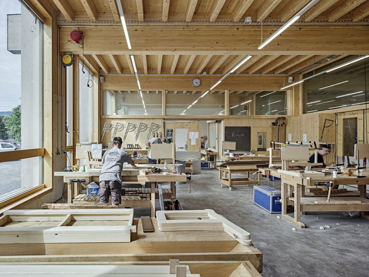 a man working in a woodworking shop with lots of workbench and tools