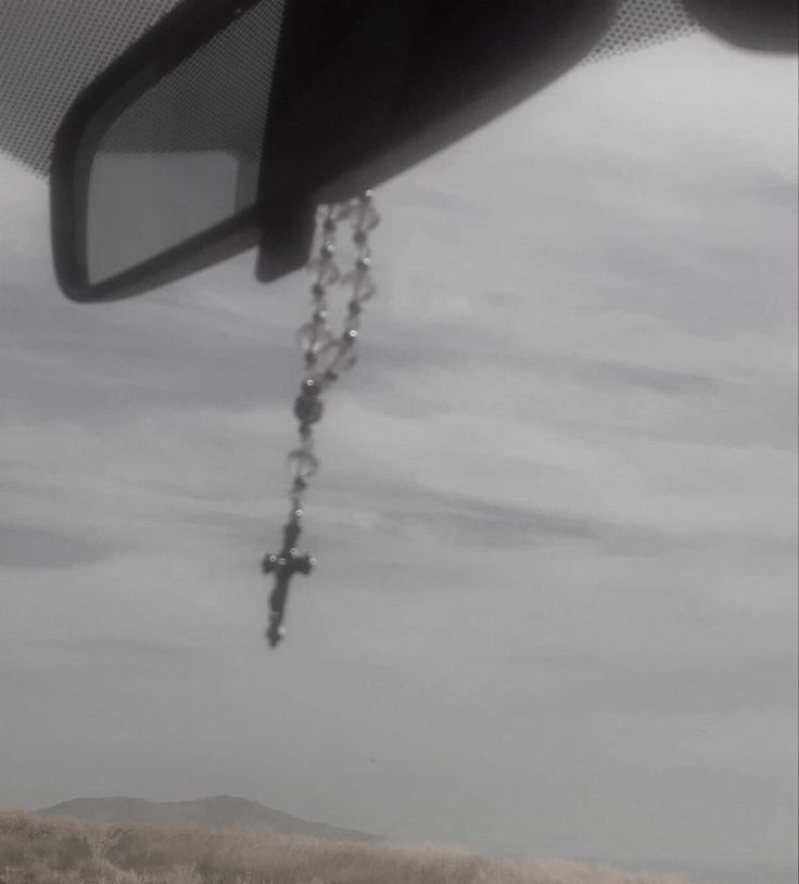 a rear view mirror hanging from the side of a car with a chain attached to it