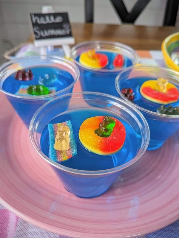 four plastic cups with gummy bears in them