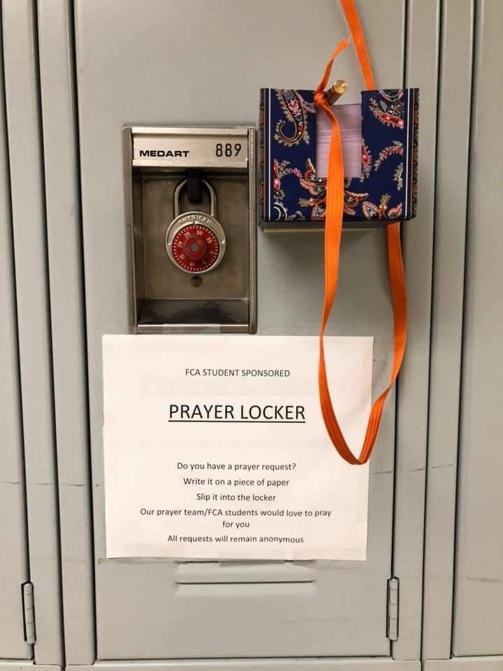 a locker with an orange ribbon attached to it