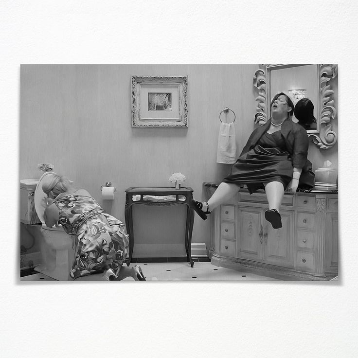 two people sitting on top of a dresser in a room with a mirror and furniture