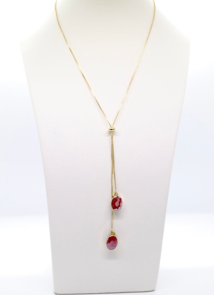 This necklace is a beautiful piece of jewelry that will add a touch of elegance to any outfit. The gold and red colors are eye-catching, and the dangling design is sure to turn heads. Red Oval Necklace For Formal Occasions, Red Oval Necklaces For Formal Occasions, Adjustable Oval Necklace Perfect For Gifts, Adjustable Oval Necklace As Gift, Adjustable Red Formal Jewelry, Adjustable Ruby Jewelry For Gifts, Formal Adjustable Necklace For Valentine's Day, Valentine's Day Formal Adjustable Necklace, Red Jewelry With Adjustable Chain For Gift