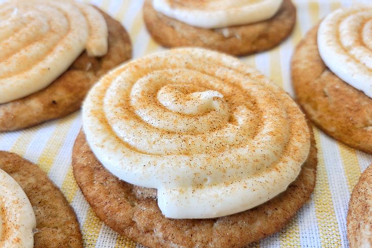 there are many cookies with icing on top of each cookie, and one has a swirl in the middle