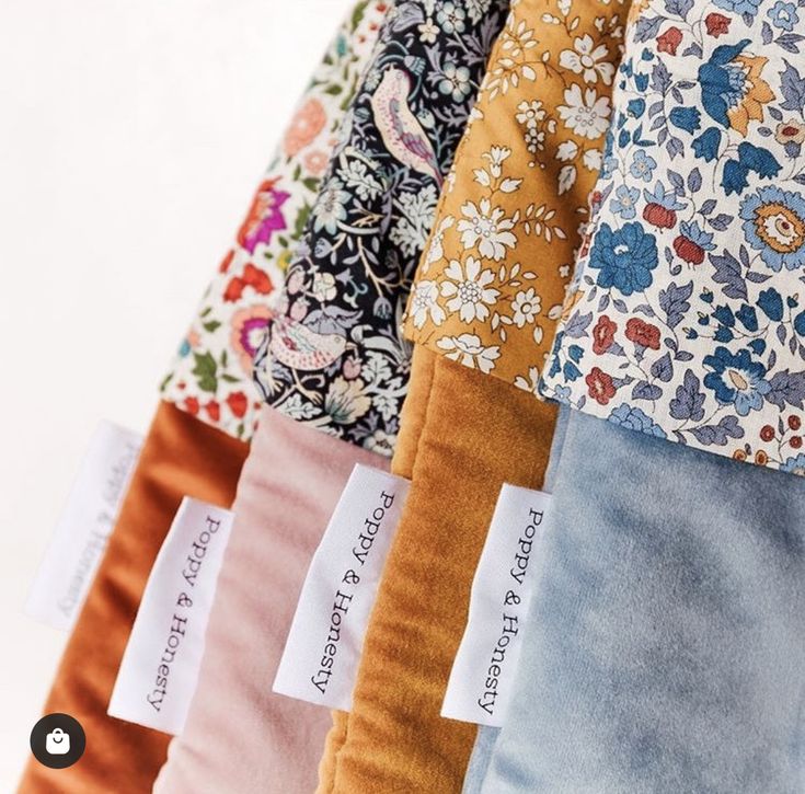 five different colors of fabric with tags on them