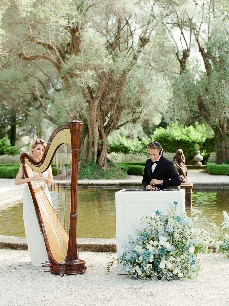 a woman playing a harp next to a man in a tuxedo