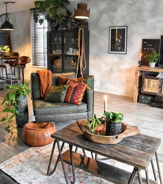 a living room filled with furniture and lots of plants on top of a wooden table