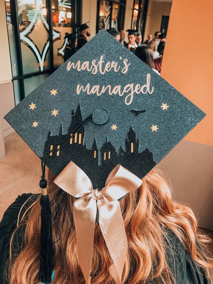 a woman wearing a graduation cap with the words master's managed written on it