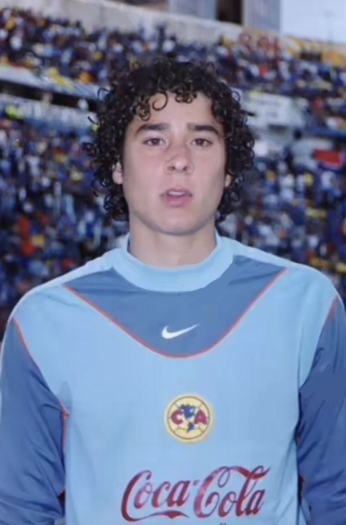 a young man standing in front of a crowd wearing a blue shirt with coca cola on it's chest