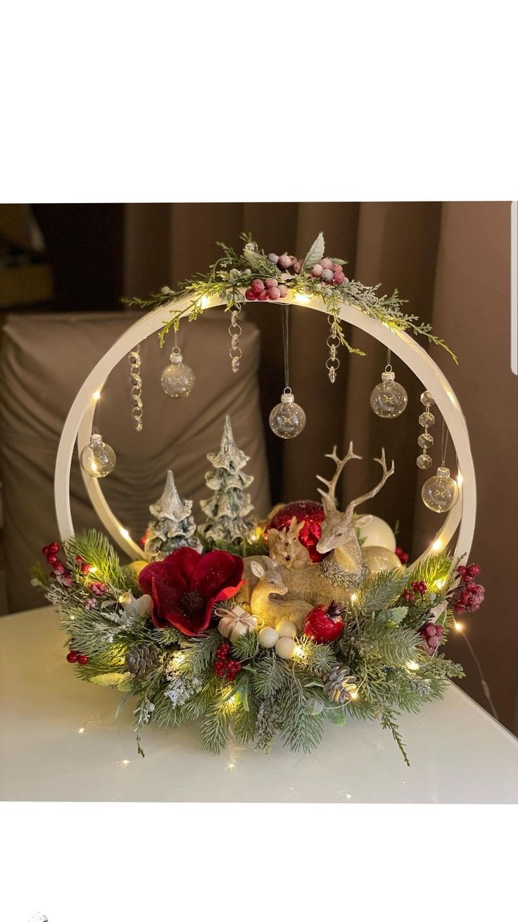 a christmas centerpiece with ornaments and lights on it's sides, including an ornament