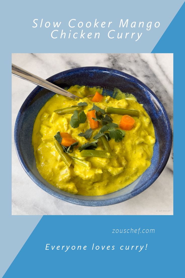 a blue bowl filled with yellow chicken curry