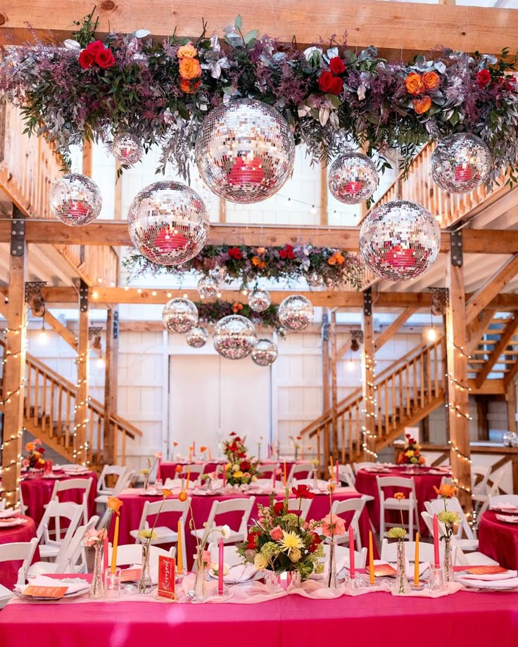 the tables are set with red linens and decorations