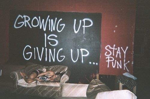 a blackboard with writing on it that says growing up is giving up stay punk