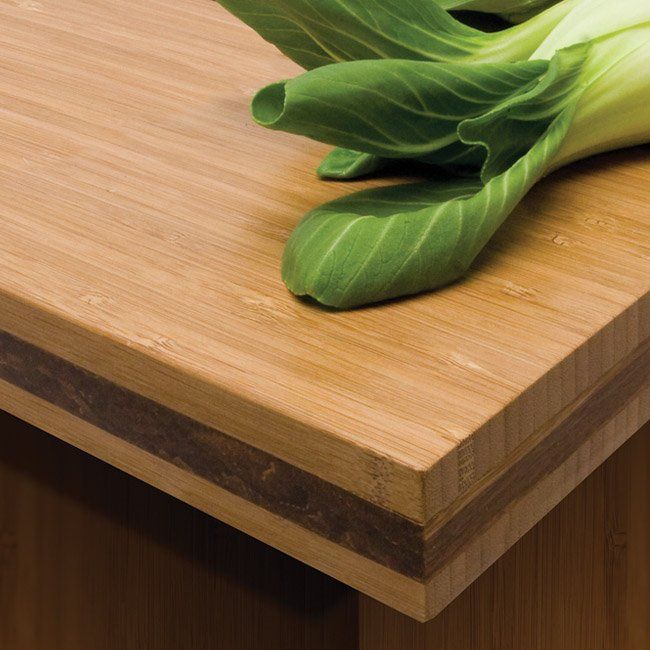 a green leafy plant sitting on top of a wooden counter