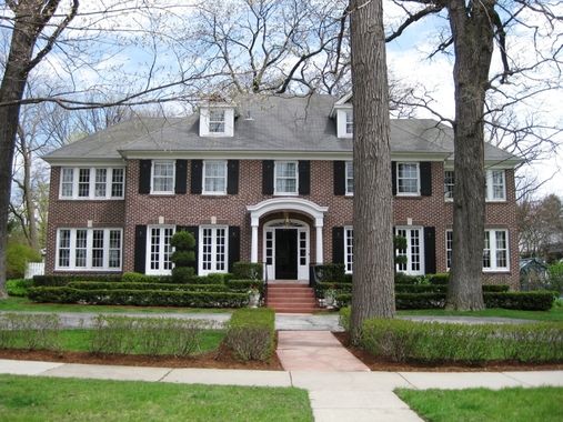 a large brick house surrounded by trees and bushes