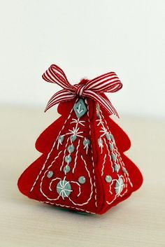 a small red christmas tree ornament on a table