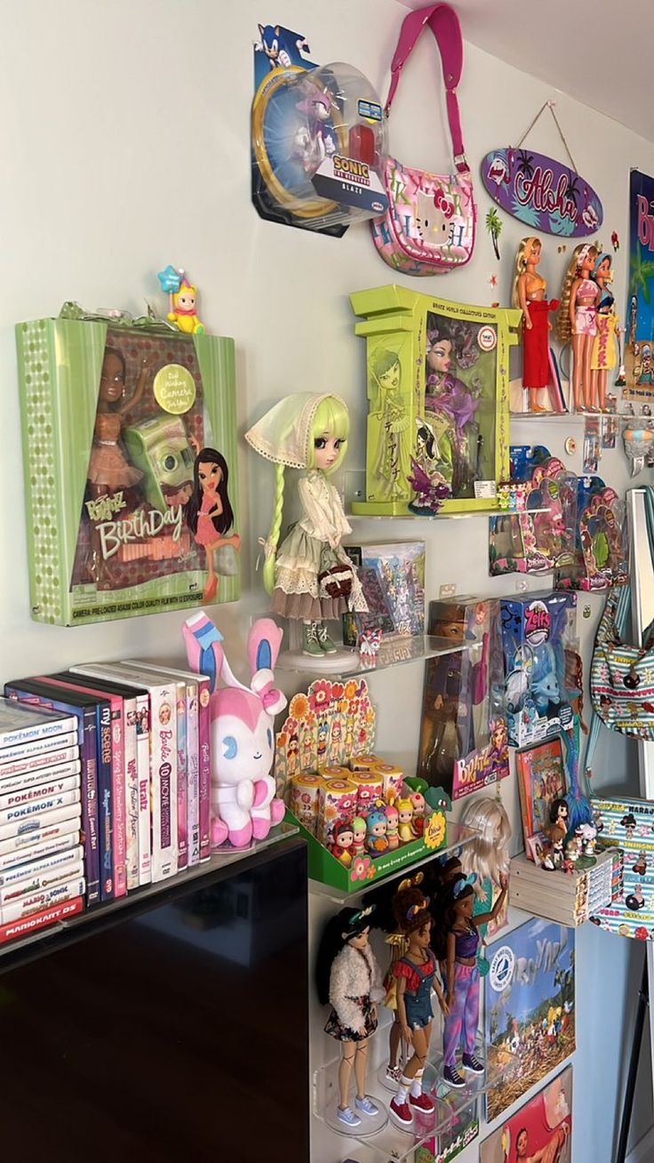 a room filled with lots of toys and dolls on the wall next to each other