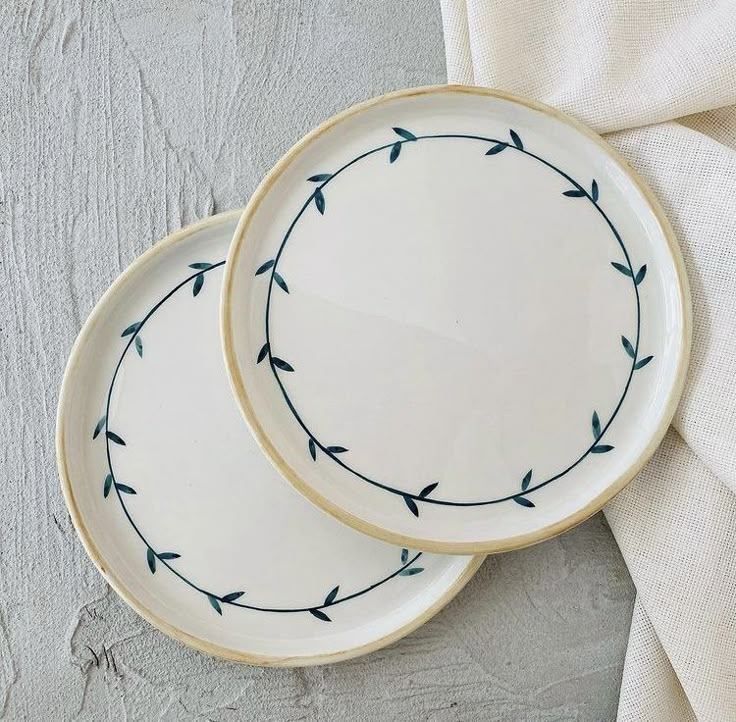 two white and blue plates sitting next to each other