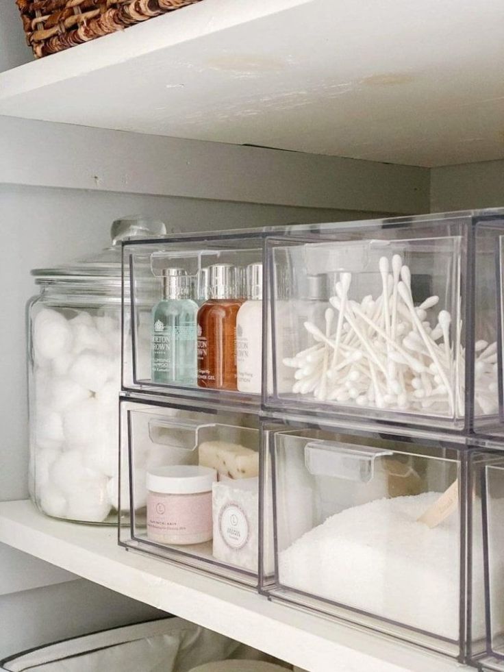 the shelves are organized with clear plastic containers