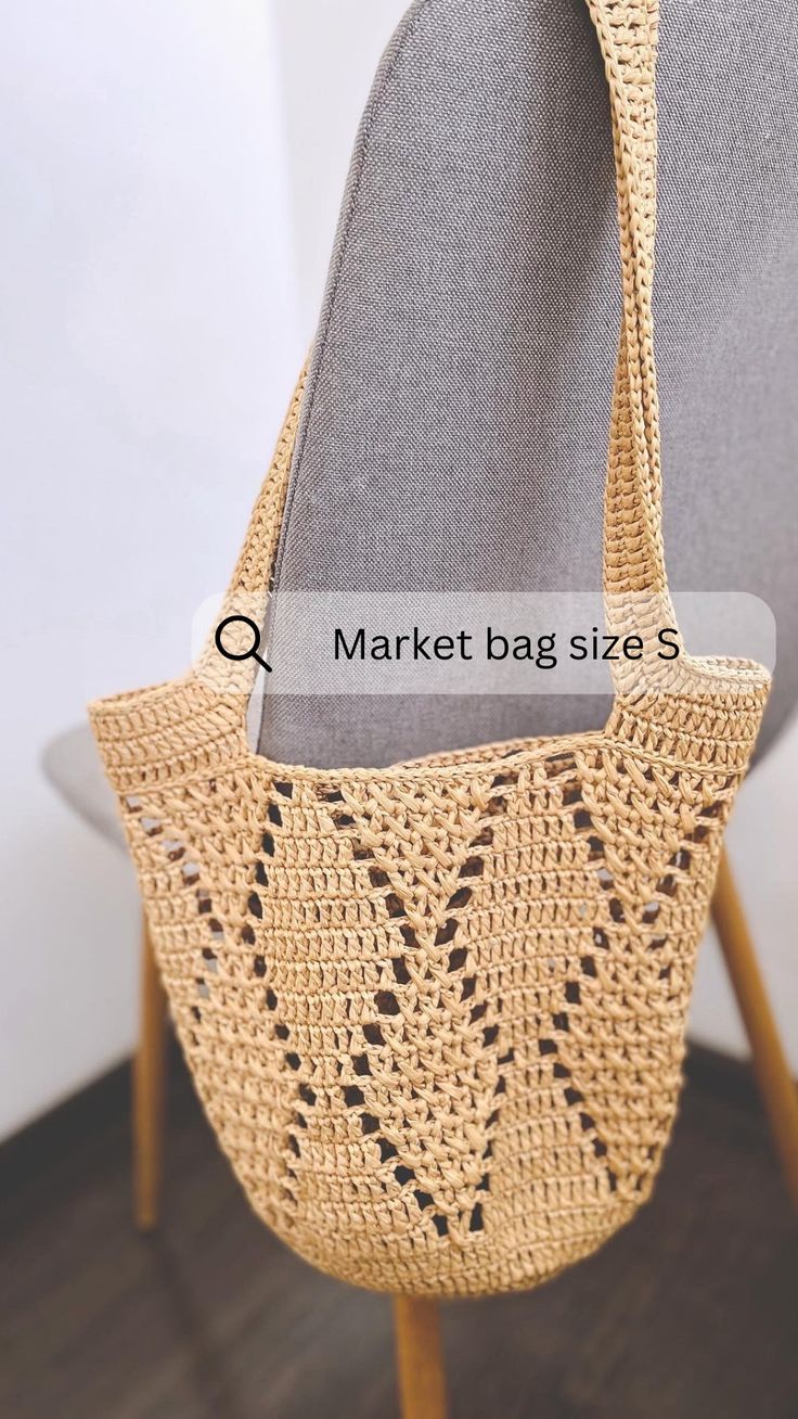 a handbag sitting on top of a chair with the words market bag size s