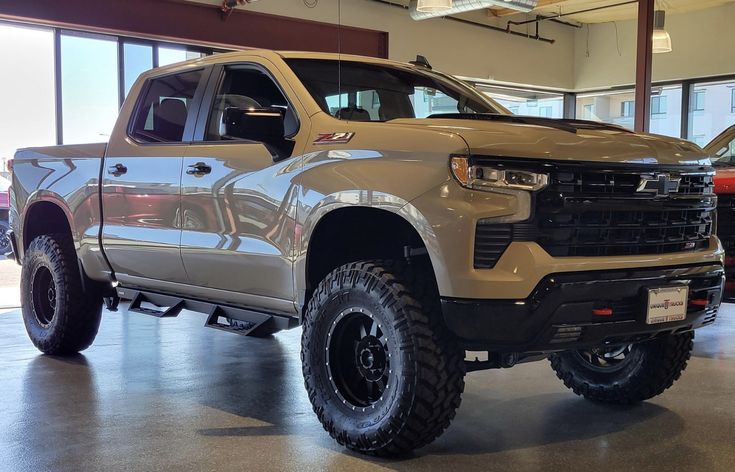 a silver truck is parked in a showroom