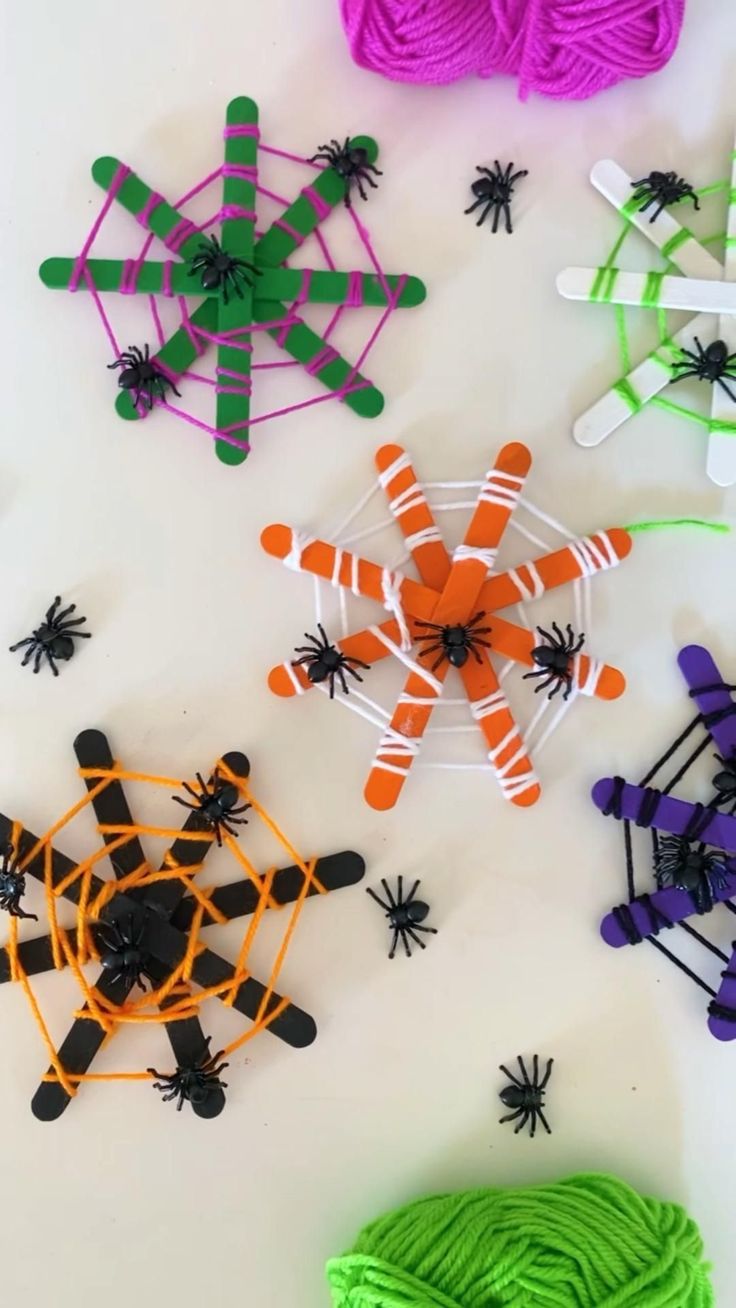 several different types of string art on a white surface with green and purple yarns