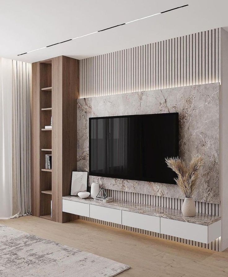 a living room with a large tv mounted on the wall