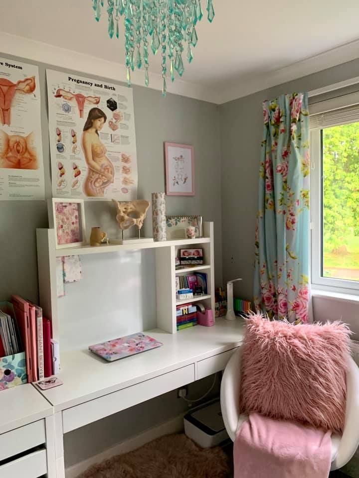 a room with a desk, chair and bookshelf