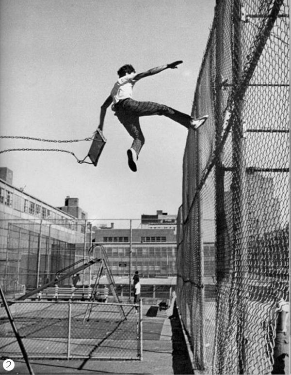 a man is jumping high in the air on a tennis court