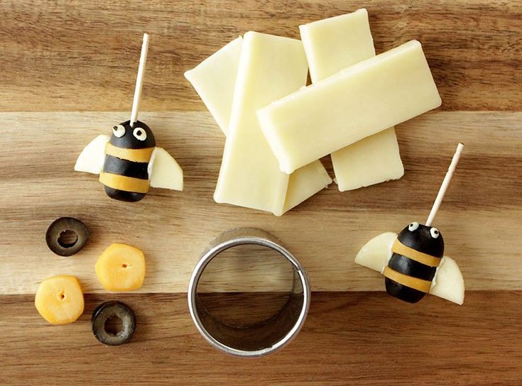 some pieces of cheese are sitting on a cutting board