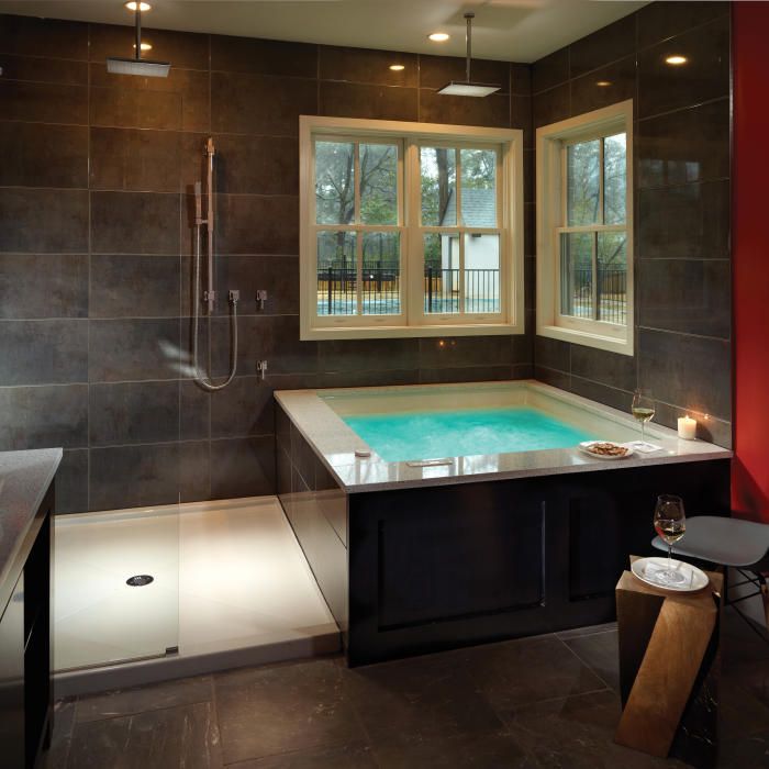 a bathroom with a large jacuzzi tub next to a window