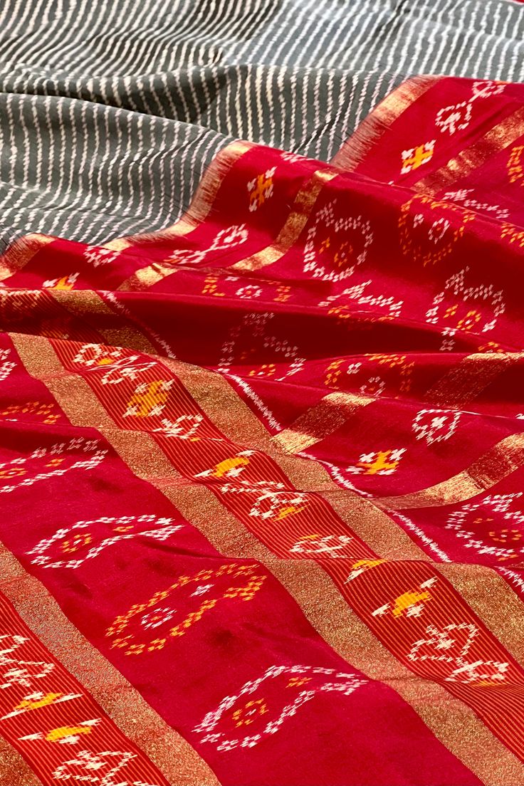 This exquisite pochampally ikkat silk saree is grey color is handwoven. The body is adorned with leheriya pattern while the elaborate broad border on one side is in maroon color with woven paisley motifs while the other side is plain along with gold zari lines. The maroon colored pallu repeats the paisley motifs along with gold zari lines. The blouse is in maroon color with lehriya pattern and decorated border in traditional ikkat designs. Approximate Length 6.5 mtrs (inclusive of blouse length) Lehriya Pattern, Paisley Motifs, Ikkat Silk Sarees, Maroon Color, Blouse Length, Grey Color, Blouse Piece, The Other Side, Tree Skirts