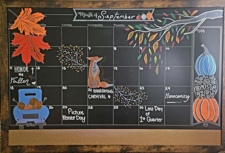 a chalk board with an autumn calendar on it