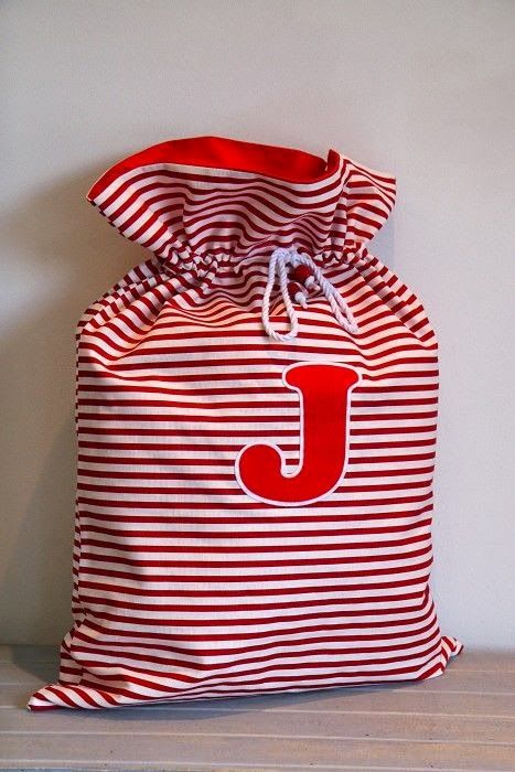 a red and white striped bag with the letter j on it