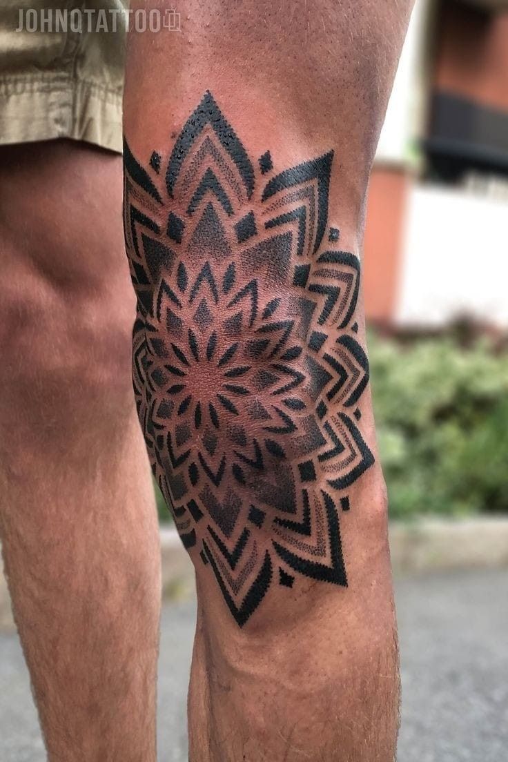 a man's leg with a tattoo on it that has a flower in the center