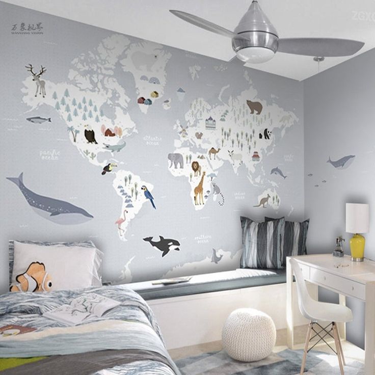 a child's bedroom decorated in gray and white with an animal map on the wall