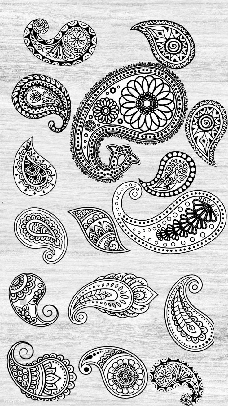 some black and white paisley designs on a wooden surface