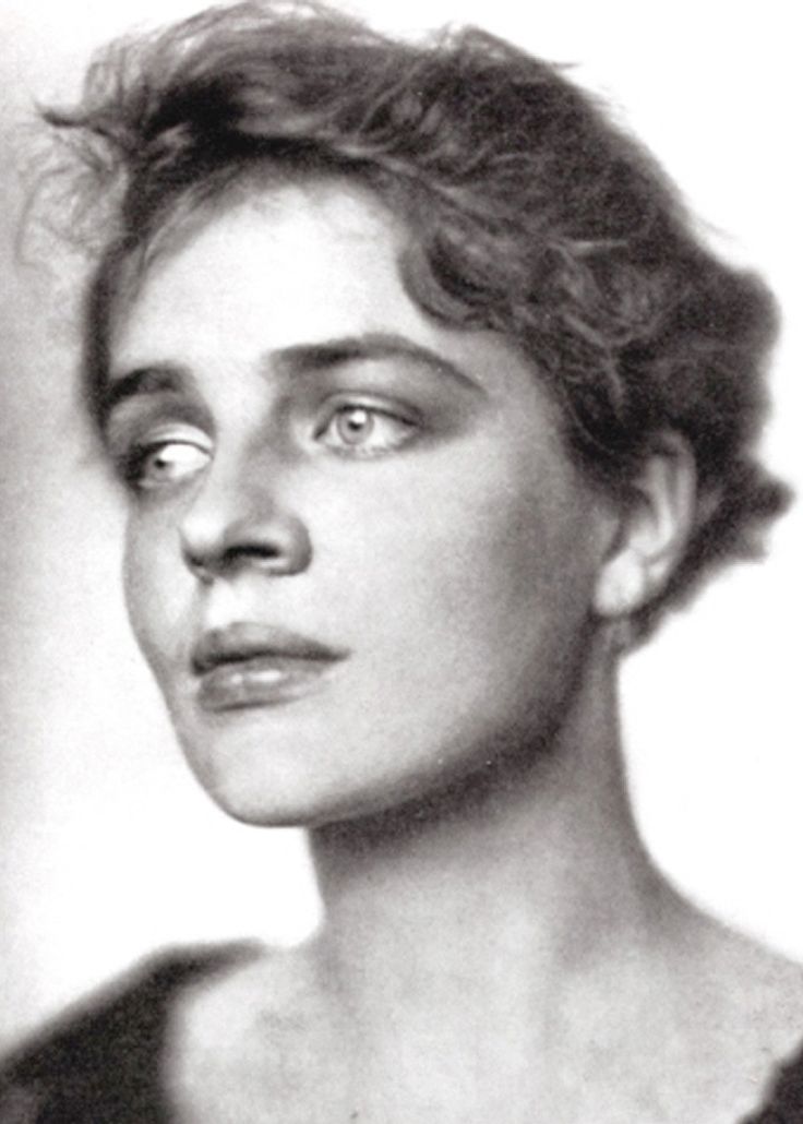 an old black and white photo of a woman's face with eyes wide open