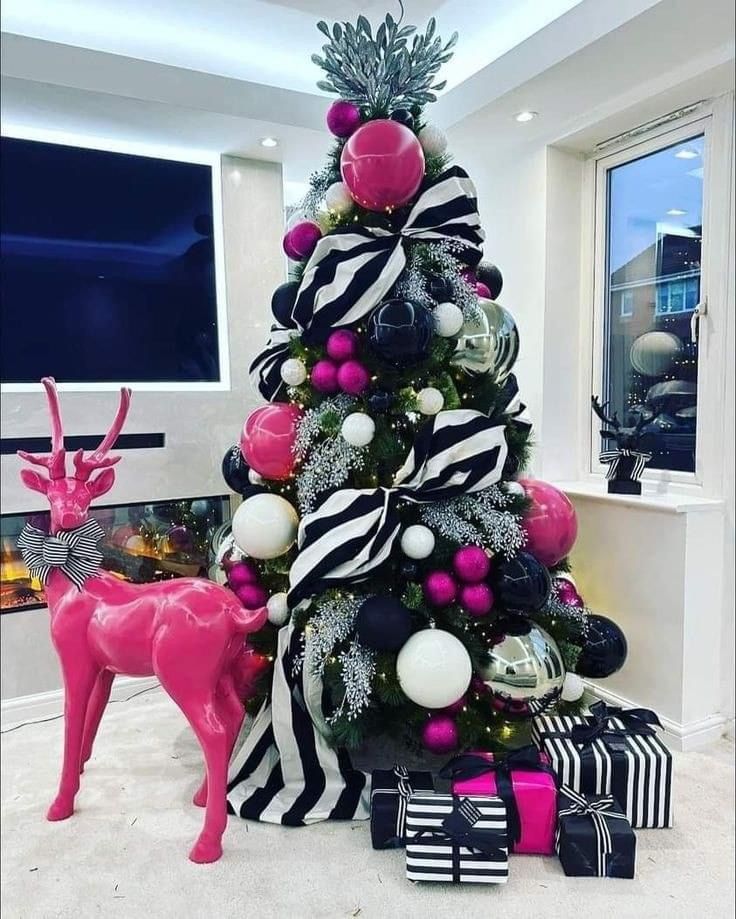 a christmas tree decorated with pink, black and white ornaments