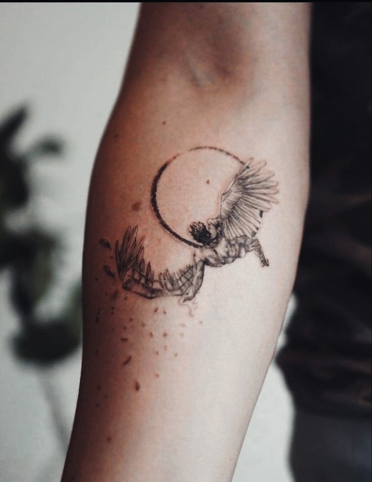 a tattoo on the arm of a person with a bird flying in front of it