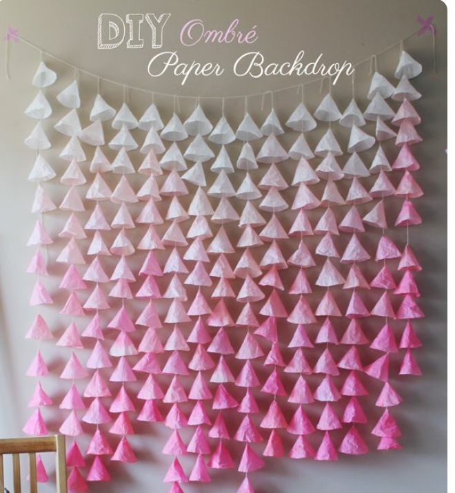 pink and white paper christmas trees hanging on the wall