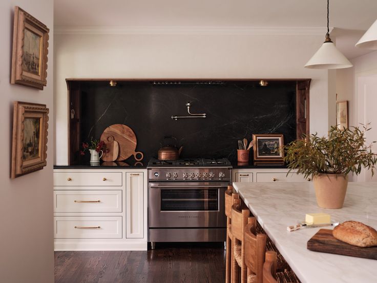 a kitchen with an oven, stove and counter tops in white painted wood paneling