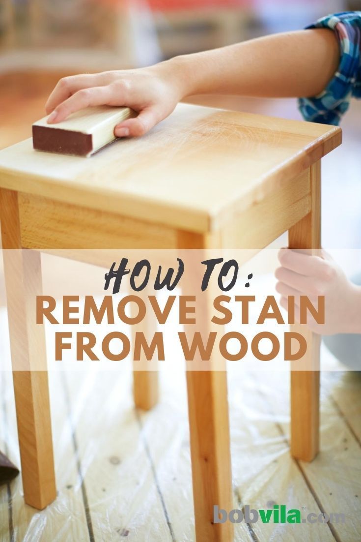 a child's hand on a wooden stool with the words how to remove stain from wood