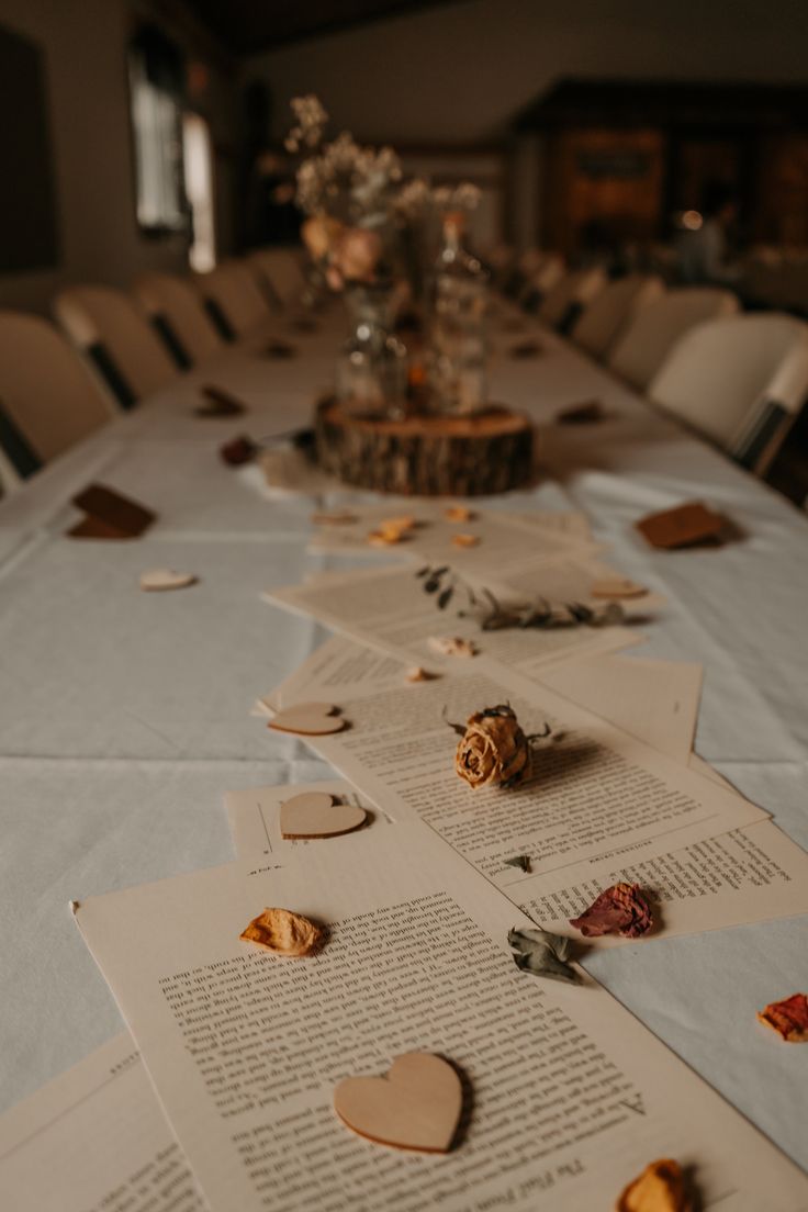 the table is covered with many pieces of paper and heart shaped confetti on it