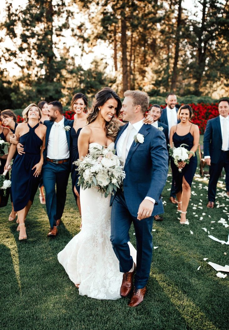 the bride and groom are surrounded by their bridal party