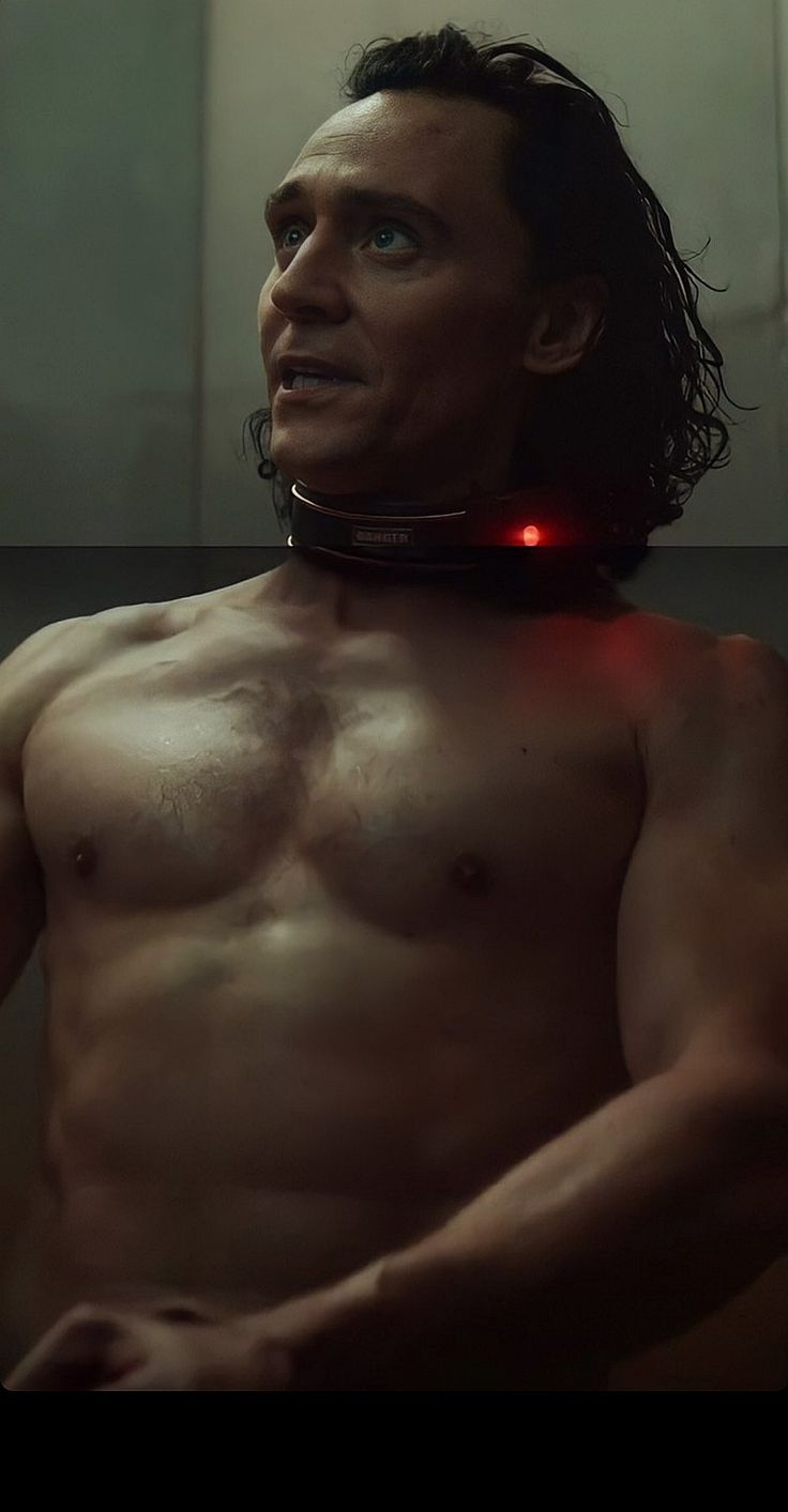 a man with no shirt wearing a red light up collar