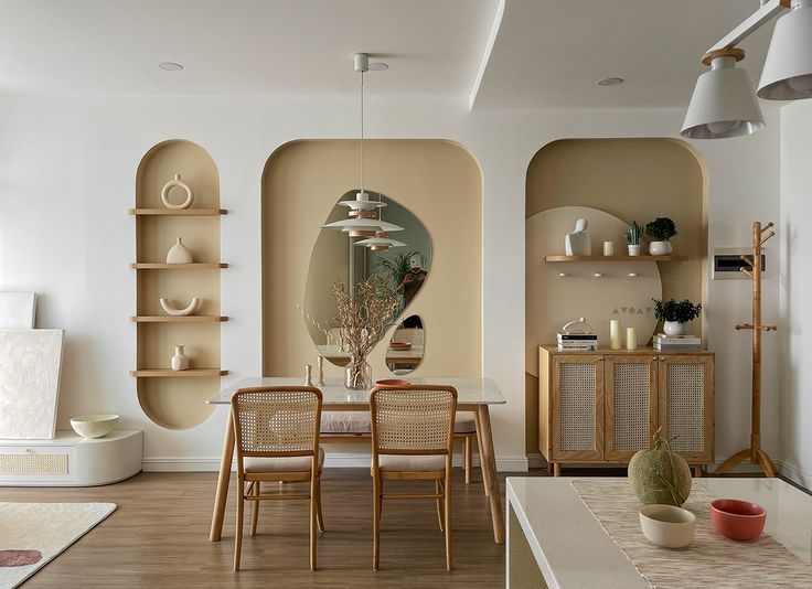 a dining room table and chairs in front of a wall with arched niches on it