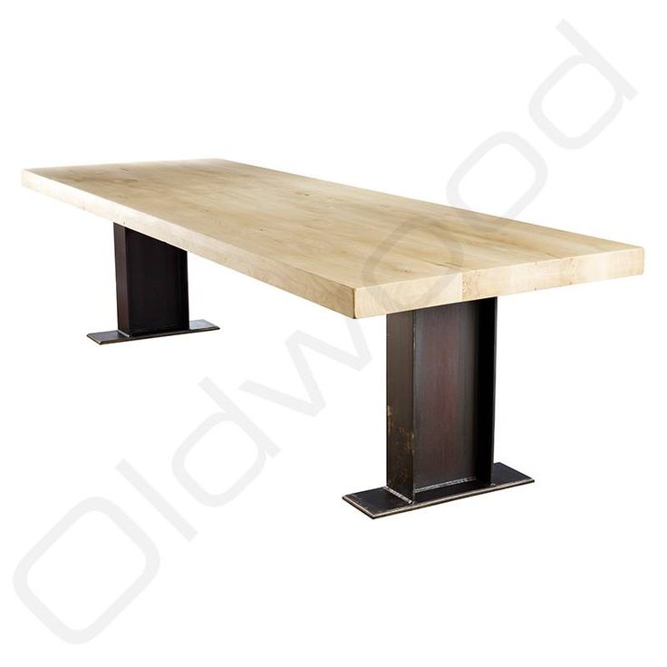 a large wooden table with two black metal legs and a wood slab on the top