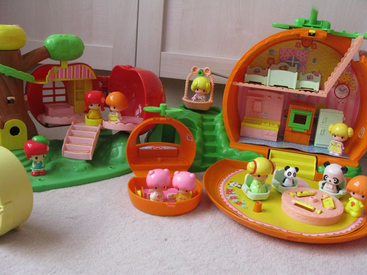 there are many toys in the room on the floor and one has a doll house